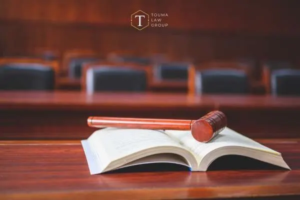 a gavel and law book on a table in a court room